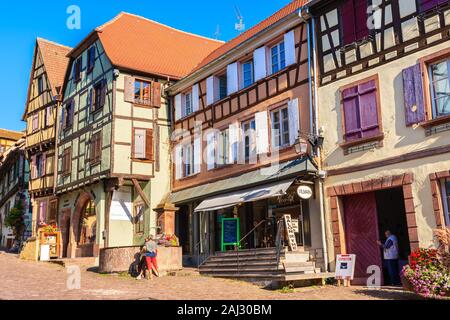 RIQUEWIHR, FRANCE - SEP 18, 2019: Beautiful historic houses in old part of Riquewihr village which is located on famous wine route in Alsace region of