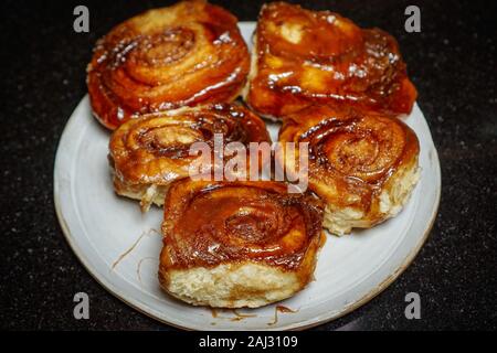 Five homemade sticky buns on a plate Stock Photo