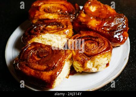 Five homemade sticky buns with dark background Stock Photo