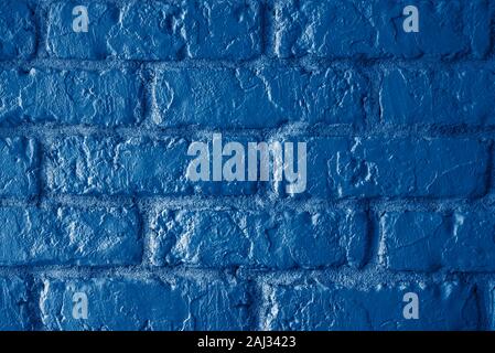 Brick wall vintage toned background in trendy classic dark blue 2020 Stock Photo