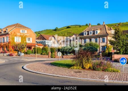 ALSACE WINE REGION, FRANCE - SEP 19, 2019: Street with typical houses and restaurants in Riquewihr picturesque village which is located on Alsatian Wi