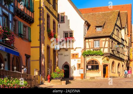 ALSACE WINE REGION, FRANCE - SEP 19, 2019: Street with typical houses in Riquewihr picturesque village which is located on Alsatian Wine Route, France