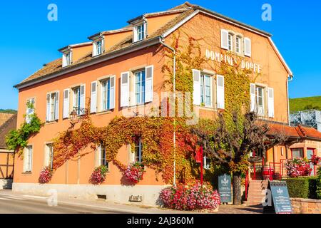 RIQUEWIHR, FRANCE - SEP 19, 2019: Beautiful historic house and winery in old part of Riquewihr village which is located on famous wine route in Alsace