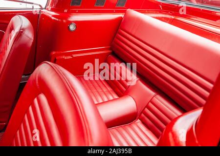 Red vinyl interior of a classic 1965 ford mustang fastback coupe Stock Photo
