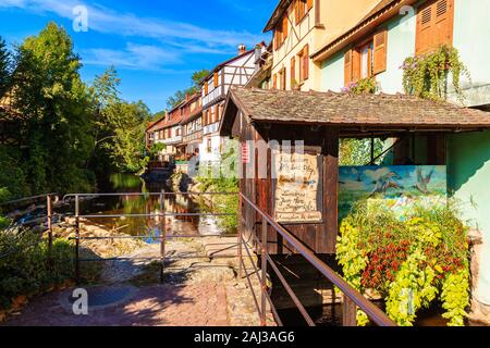 ALSACE WINE REGION, FRANCE - SEP 20, 2019: Beautiful narrow street and colorful houses decorated with flowers in Kaysersberg village which is located Stock Photo