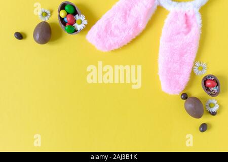 Chocolate Easter eggs on pastel yellow background flat lay. Easter concept. Copy space. Stock Photo