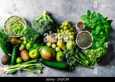 Variety of Green Vegetables and Fruits on the grey background Stock Photo