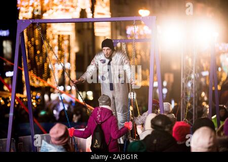 Moscow, Russia. 2nd Jan, 2020. A performer wearing a cosmonaut suit swings on a double-swing during the 2020 New Year Celebrations in central Moscow, Russia, on Jan. 2, 2020. The New Year festivities on Tverskaya Street of central Moscow is themed on space exploration this year. Credit: Maxim Chernavsky/Xinhua/Alamy Live News Stock Photo