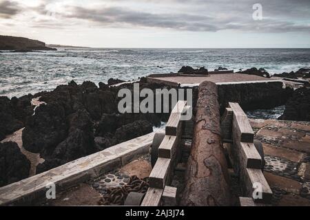 Old cannon facing the ocean in the Castillo de San Miguel fortress in Garachico, Tenerife, Spain. Stock Photo