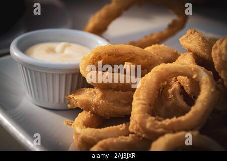 Fried calamares with alioli, typical snack served in the most of Spanish beach bars on Malaga coast. Stock Photo