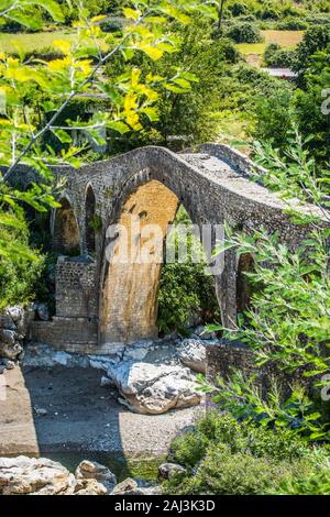 Old ottoman bridge Ura e Mesit near village Boks in Albania Stock Photo