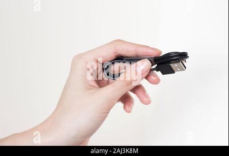 Woman holding a USB to Micro USB cable Stock Photo