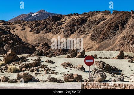 Red 'No entry' sign next to a car park, against volcanic deesert backdrop of Teide National Park in Tenerife, Canary Islands, Spain. Stock Photo