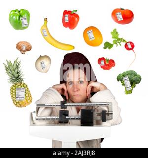 Mature woman in bathrobe standing on a bathroom scale looking perplexed surrounded by fruits and vegetables with nutrition labels. Stock Photo