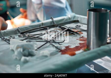 Close up of medical surgical equipment or tools being used for an operation in operating theater at a hospital. Stock Photo