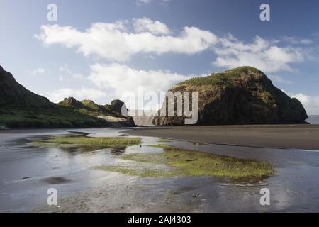 The rock mountains of the black sand beach Whatipu on the west coast of Auckland, New Zealand. Stock Photo