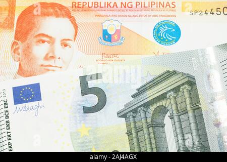 an orange twenty piso note from the philippines close up in macro with a five euro note from the european union eurozone stock photo alamy