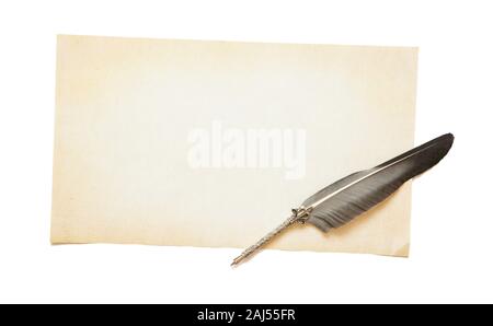 Empty yellowed sheet of old paper with copy-space and beautiful silver antique feather. Concept of literary creativity Stock Photo