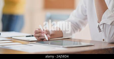 Cropped shot of young professional ux web developer working on her project while using digital tablet Stock Photo