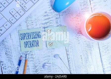 Conceptual hand writing showing Supervising Operator. Concept meaning monitoring and coordinating the plant operations Writing equipment and computer Stock Photo