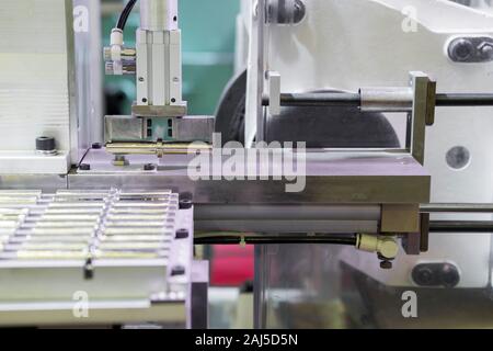 Robot  arm pick small machined parts to next manufacturing process , machining ; industrial engineering equipement process background Stock Photo
