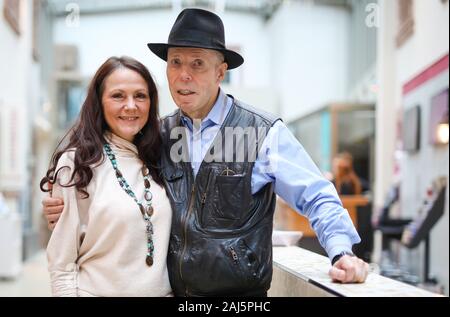 Heidelberg, Germany. 27th Dec, 2019. Plastinator Gunther von Hagens (r) stands together with his wife Angelina Whalley in the foyer of his 'Body Worlds Museum'. The controversial anatomist celebrates his 75th birthday on 10 January 2020. (to dpa 'A Life for Plastination - Gunther von Hagens turns 75') Credit: Christoph Schmidt/dpa/Alamy Live News Stock Photo