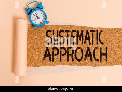 Writing note showing Systematic Approach. Business concept for A process used to determine the viability of a project Alarm clock and torn cardboard o Stock Photo