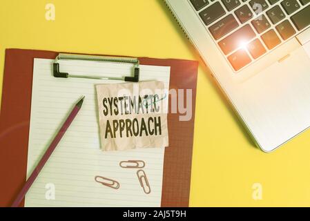 Writing note showing Systematic Approach. Business concept for A process used to determine the viability of a project Laptop clipboard paper sheet cli Stock Photo