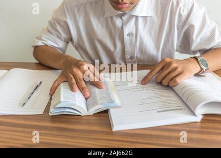 Young student reading books and studying Stock Photo