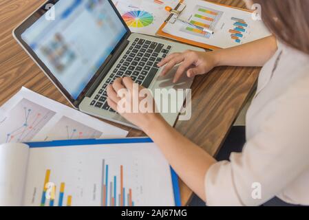 Hand of female tapping on mouse touchpad Stock Photo
