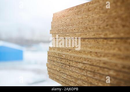 Close-up of wood particle boards on the table in workshop Stock Photo
