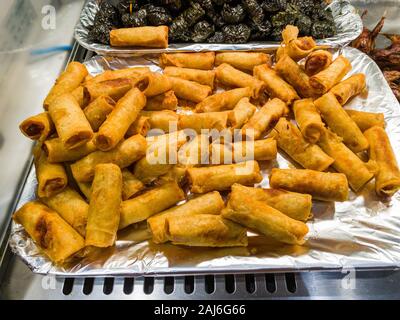 Pile of deep-fried spring rolls on food tray at hypermarket Stock Photo