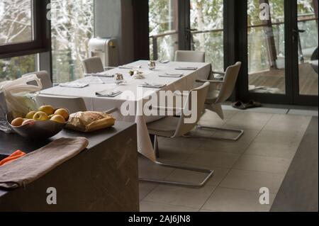 A dining room with served table, focus in the foreground Stock Photo