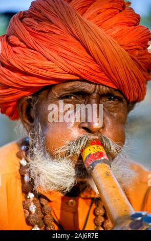 Snake charmer entertaining the visitors of Pushkar Camel Fair Stock Photo