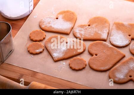 Preparation for the holiday. Preparing for the new year. Gingerbread blanks before baking. Gingerbread cookies with holes for hanging on a Christmas t Stock Photo