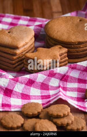 Preparation for the holiday. Baked gingerbread cookies for the new year. Gingerbread blanks before drawing. Gingerbread cookies with holes for hanging Stock Photo