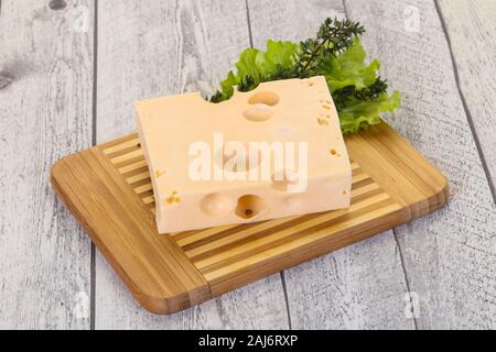 Maasdam cheese brick with thyme branch Stock Photo