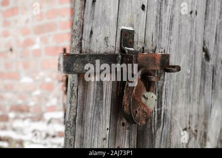 old lock on wooden door and deadbolt with shallow depth of field Stock Photo