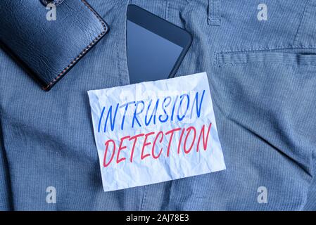 Text sign showing Intrusion Detection. Business photo text monitors a network or systems for malicious activity Smartphone device inside trousers fron Stock Photo