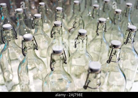 many empty glass bottles with corks, glass empty bottles with white corks background. Stock Photo