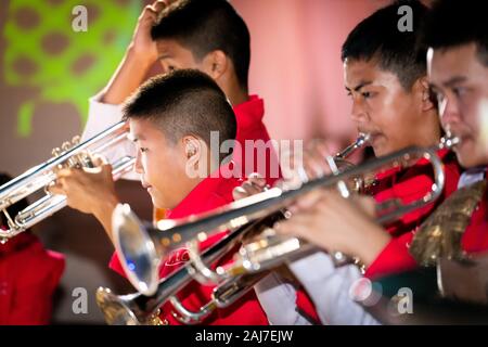 Young Thai boys playing brass instruments for a festival in Chiang Mai In northern Thailand. Photograph: Tony Taylor Stock Photo