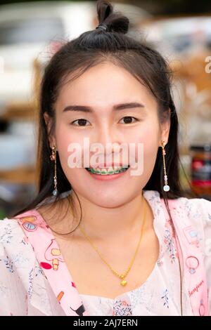 At the coffee market in Chiang Mai... amazing dark eyes and I love the green dental braces! Photograph: Tony Taylor Stock Photo