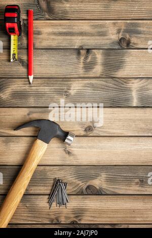 Top view of the hammer and carpenter's work tools on an antique wooden table. Construction industry, do it yourself. Text space. Stock Photo