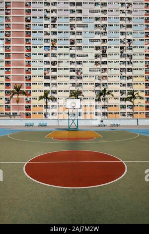basketball court and rainbow colored building facade in HongKong - Stock Photo