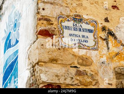 Street sign with traditional Portuguese azulejo tiles on an old brick ocre wall Portugal. Photograph: Iris de Reus Stock Photo