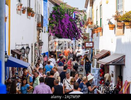 Daily bustle os tourists visiting the Portuguese town Obidos, which is completely walled in and is an important attraction in its entirety Stock Photo