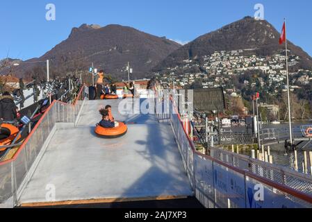 Lugano, Switzerland - 10 July 2016 - children who practice ice tubing at Lugano on Switzerland Stock Photo