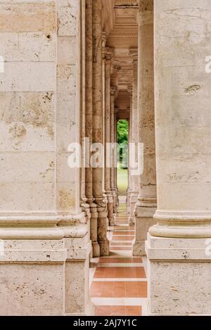 Arch corridor. Architecture for high columns. Narrow long passage among high colons in antique style Stock Photo