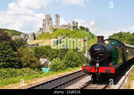 Steam engine 6695 passing Corfe Castle on the Swanage Railway, Dorset, England Stock Photo