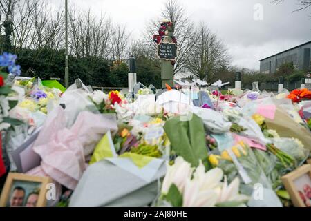 Floral tributes that have been left at the scene in Stanwell, near London's Heathrow Airport, of a fatal crash on New Year's Eve in which three British Airways cabin crew died.